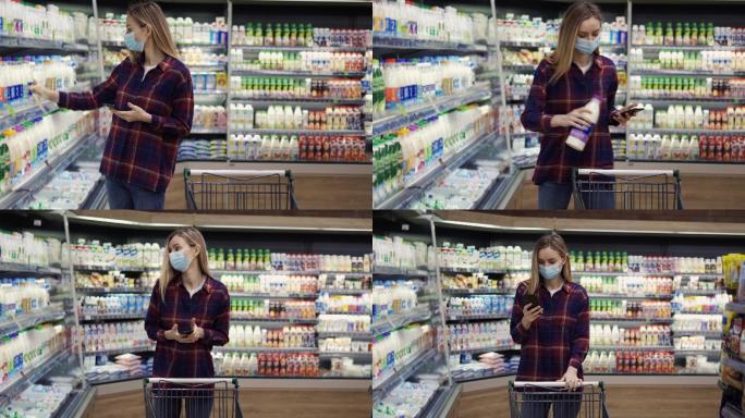 女人在超市用智能手机挑选牛奶，查看购物清单