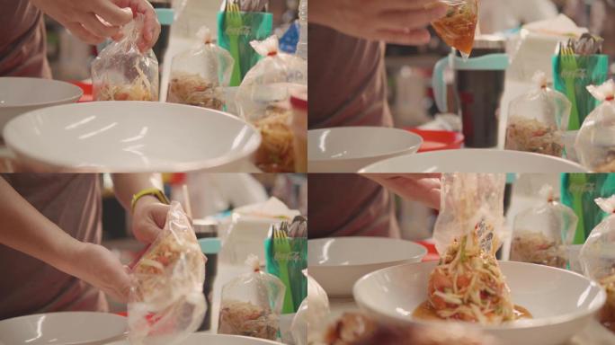 女性从塑料袋里拿出菜准备在桌上吃