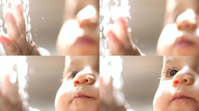 婴儿手触摸水龙头流出的水