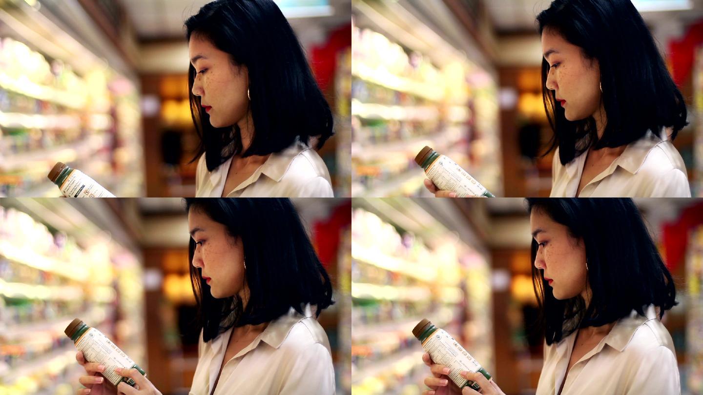 女性在超市购物精挑细选采购甄别