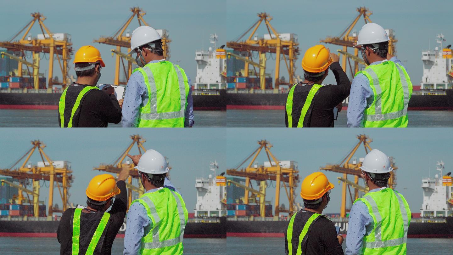 工程师在商业港口与码头工人进行交谈。