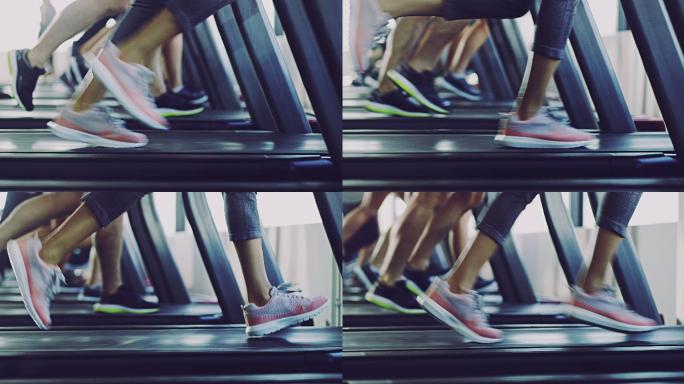 人们在健身房跑步机上锻炼