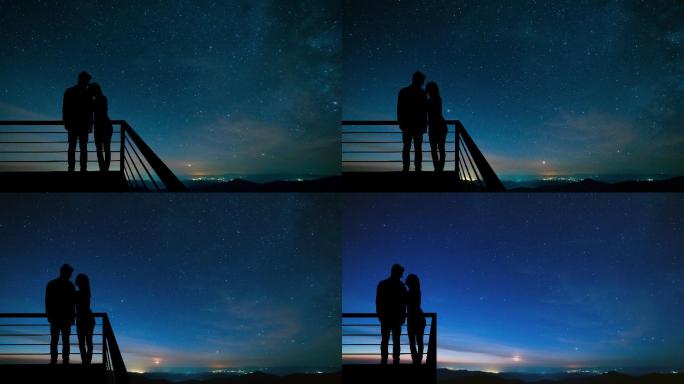 这对夫妇站在星空背景下的阳台上。