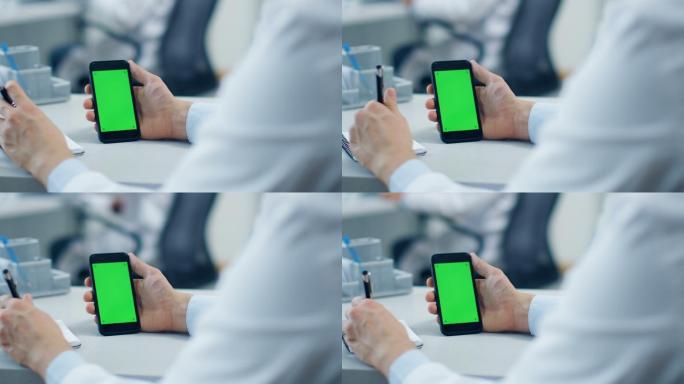 男医生使用绿色屏幕智能手机