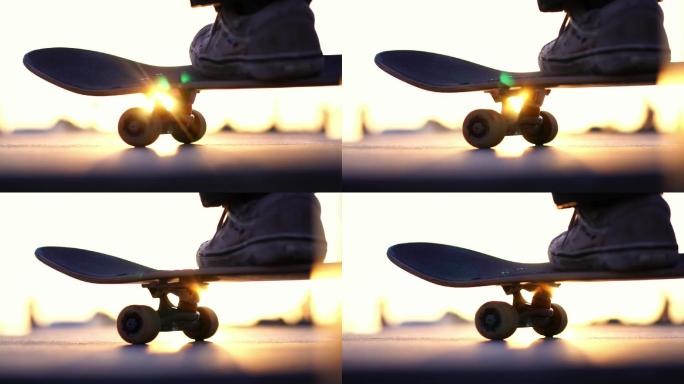 日落下的特写滑板滑板少年年轻人运动
