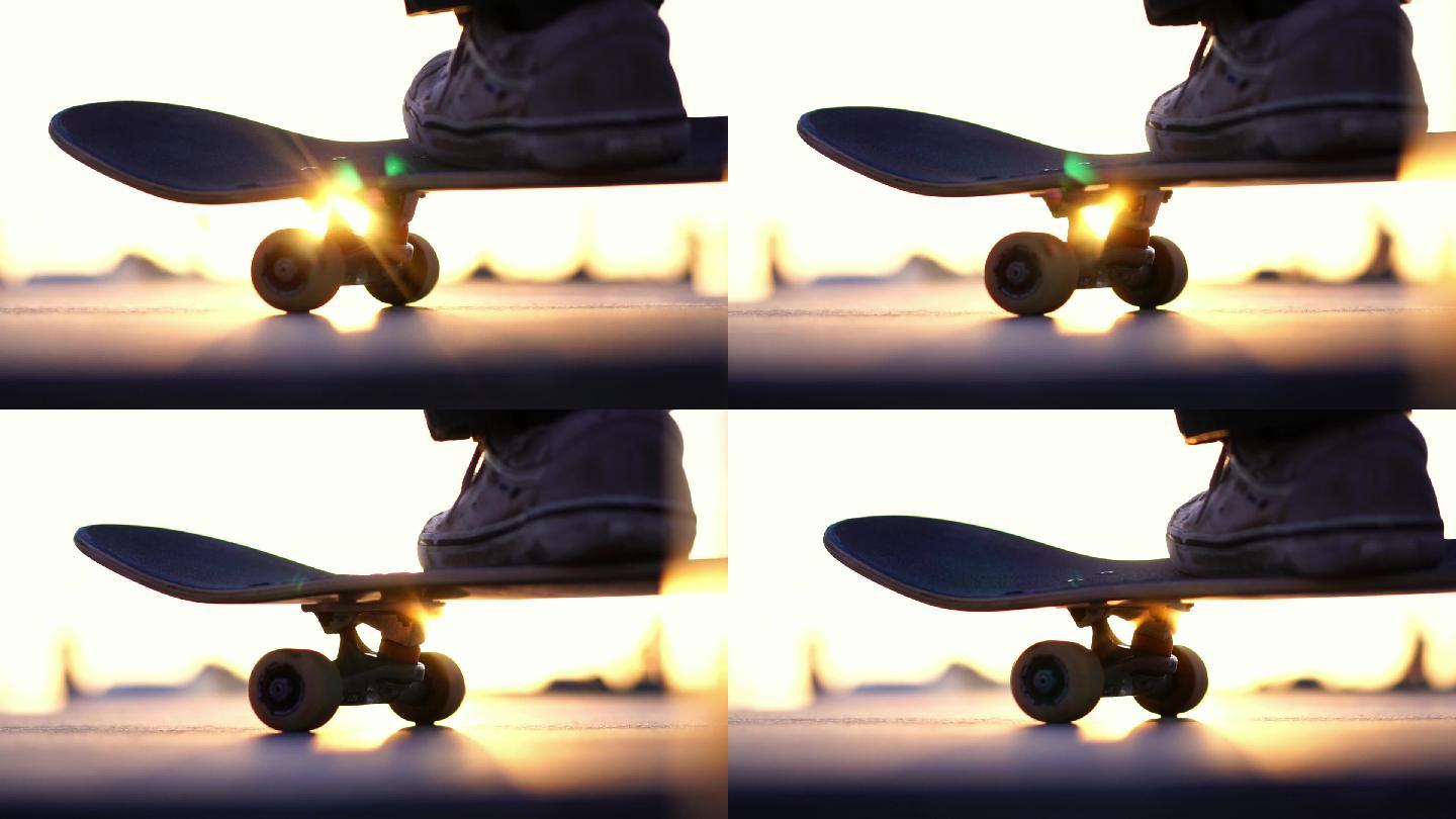 日落下的特写滑板滑板少年年轻人运动