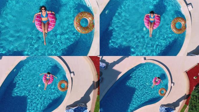 女子躺在油炸圈饼形状的充气圆环上