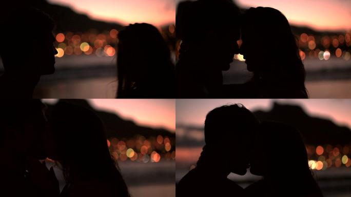 情侣在海滩上接吻的剪影