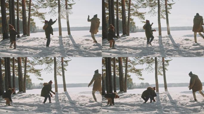 一家人在阳光明媚的冬日扔雪球