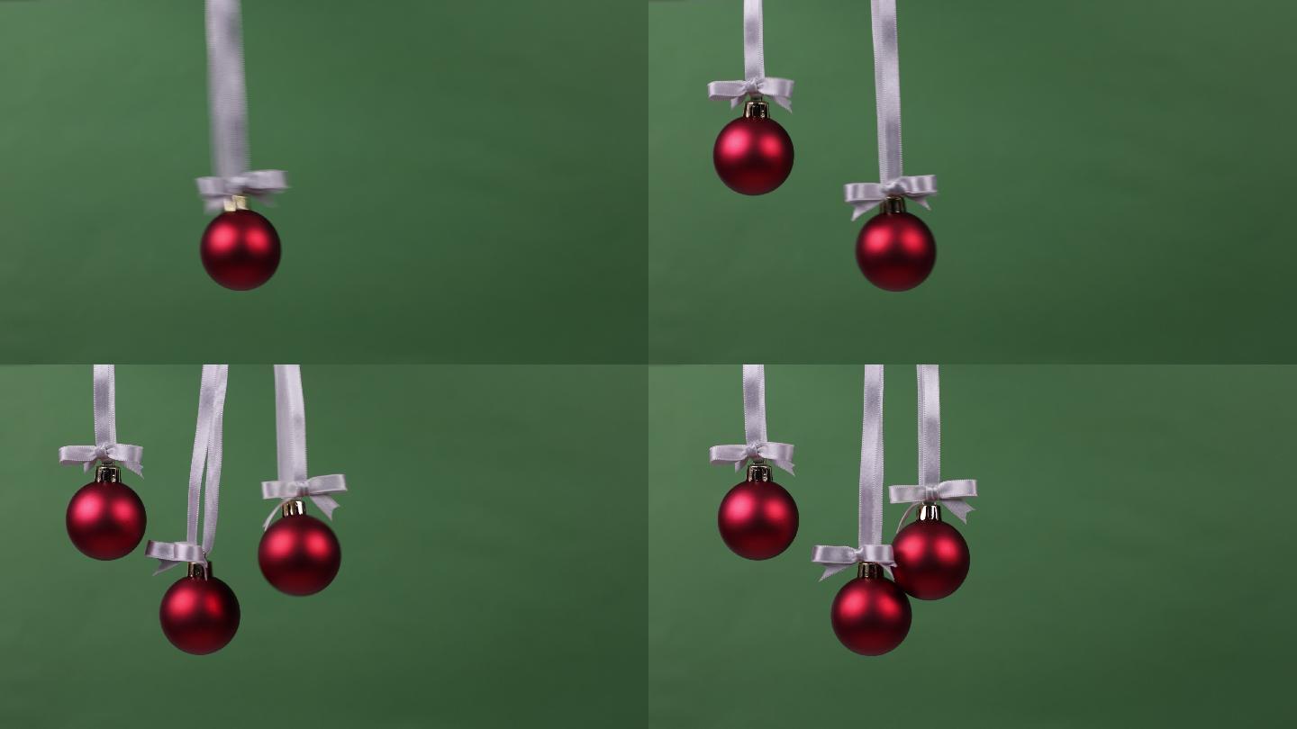 三个圣诞装饰球一个接一个落下