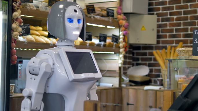 一个机器人在面包店柜台工作。