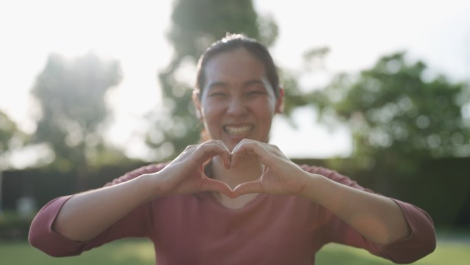 女人把手放在胸前比心