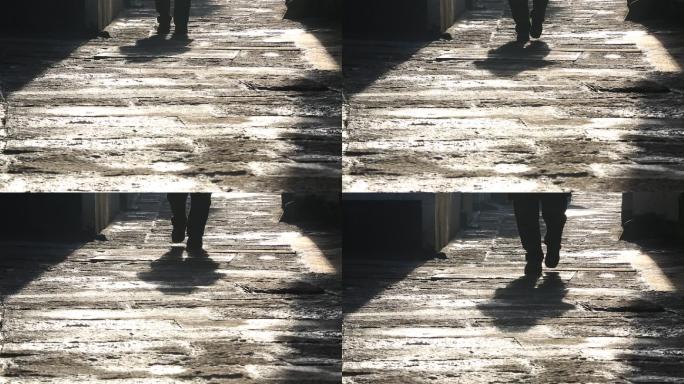 冬天早晨阳光石板路老人老街脚步特写原素材