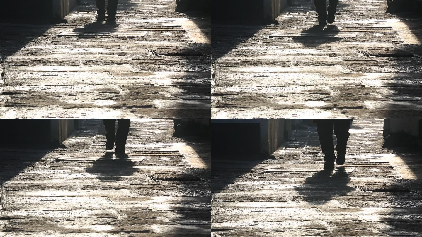 冬天早晨阳光石板路老人老街脚步特写原素材