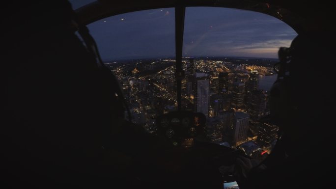 西雅图建筑物上空飞行的直升机驾驶舱看夜景