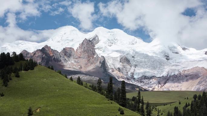 晴天白云下的草甸雪山