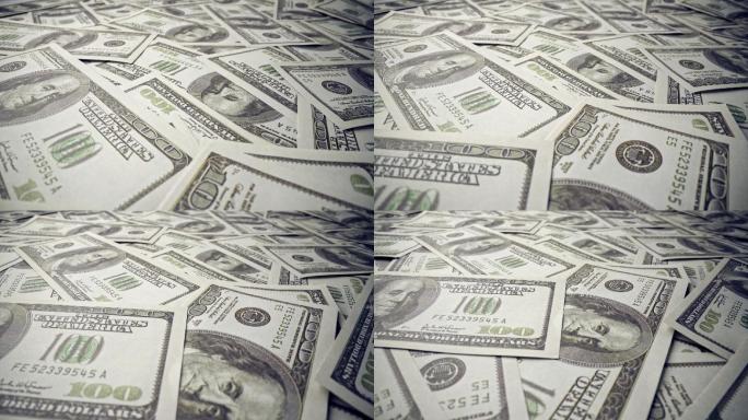 办公桌上堆满了一百美元的美钞。