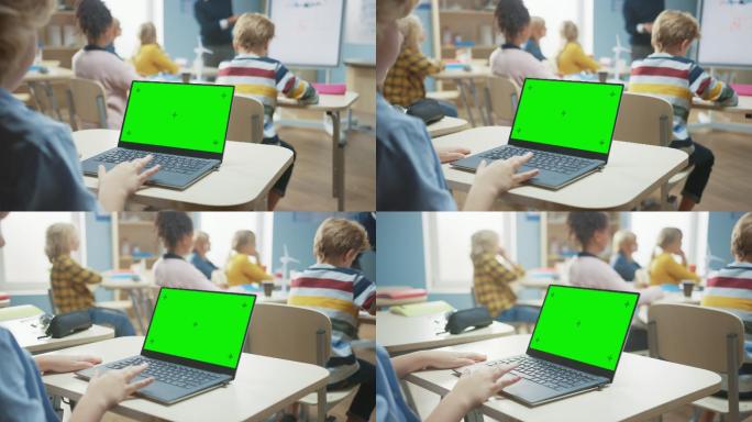 一个孩子在课堂上使用绿色模拟屏幕电脑
