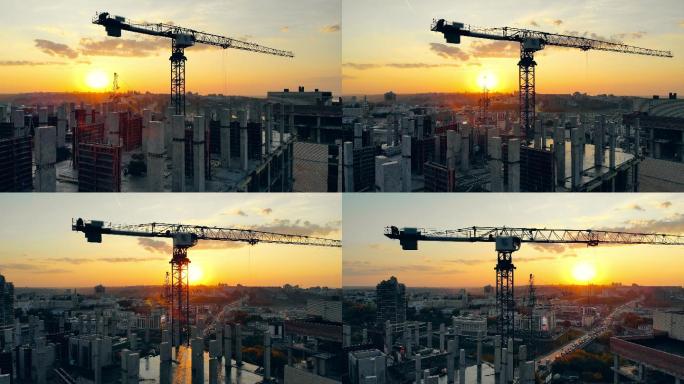 日落时使用起重机的城市施工现场