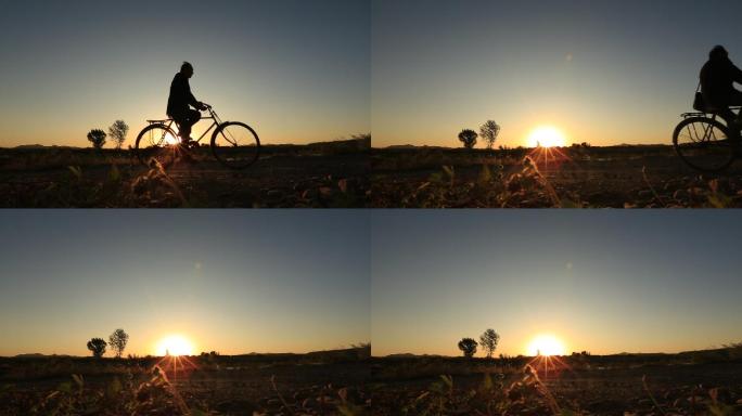 夕阳下骑自行车的乡村干部