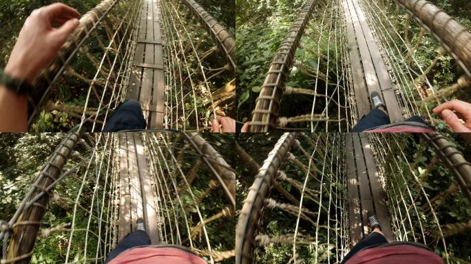 在丛林中，一名男子越过吊桥