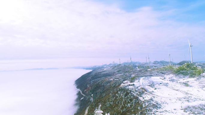 4k航拍山顶云海云雾雪景风力发电机