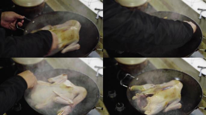 一位厨师在烹饪鸭子，给鸭子烫皮煎香