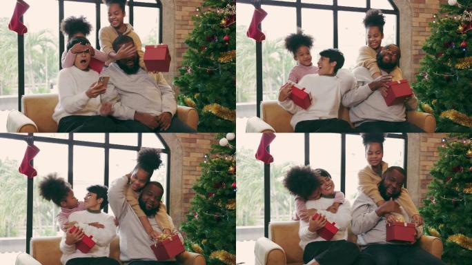 圣诞节，两个孩子拿着礼物盒给爸爸妈妈惊喜