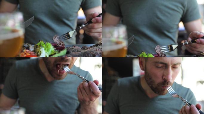 男人切牛排肉，蘸酱吃的特写镜头