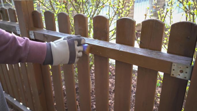 男人在花园里翻修木栅栏。