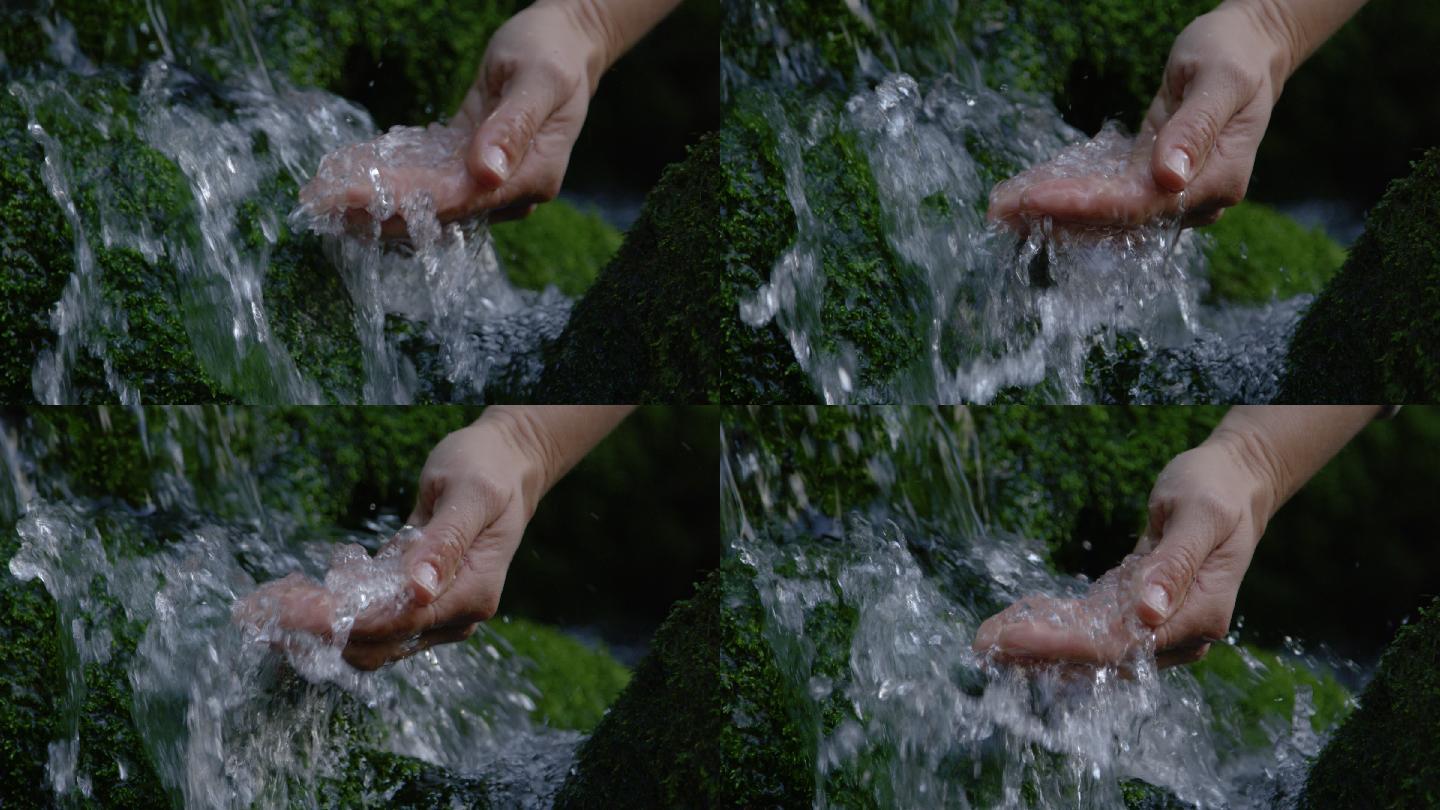 特写：口渴的人用手舀一把冷水。