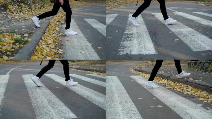 穿运动鞋的男孩走在人行横道上