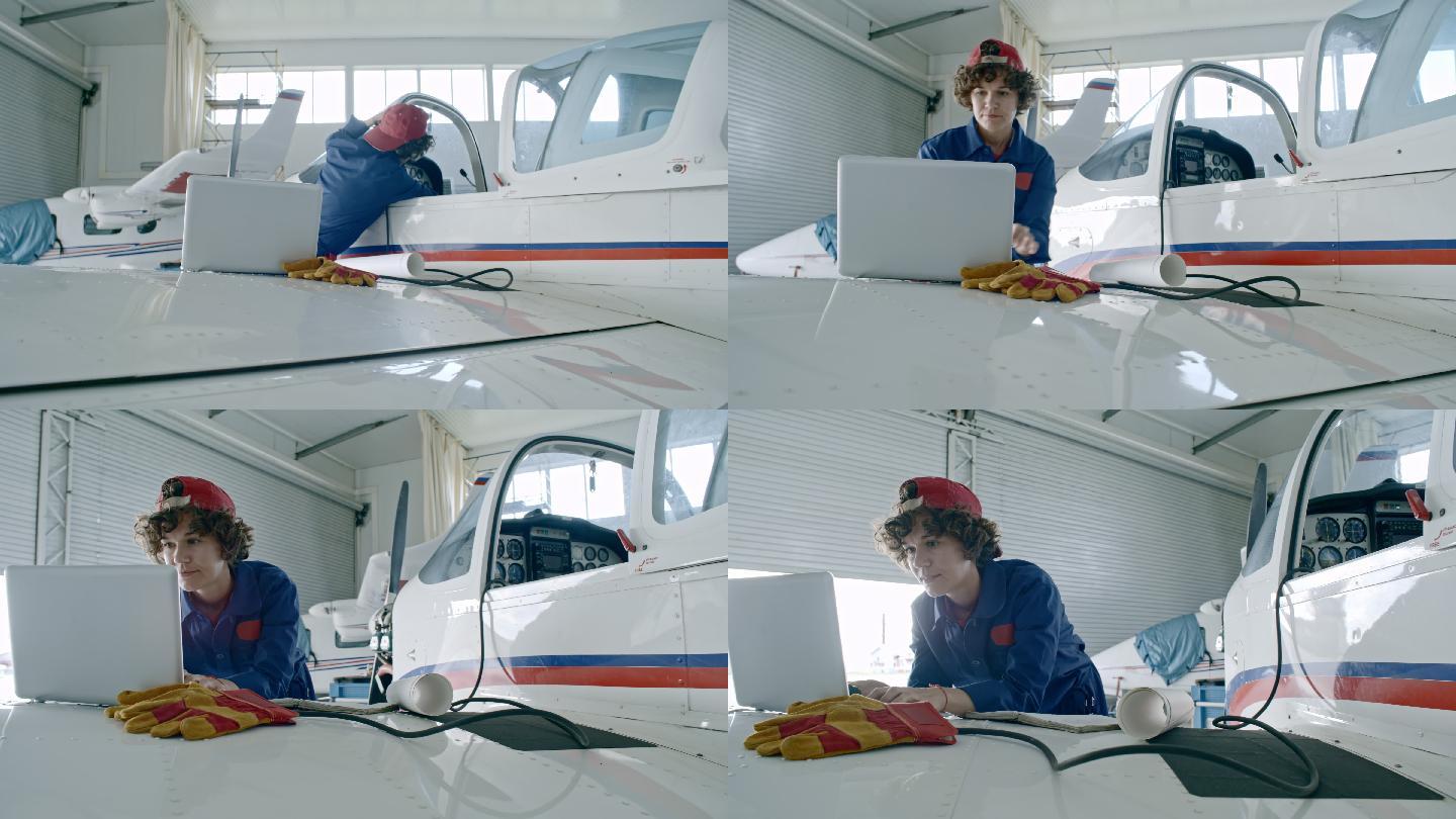 女工程师在测试飞机发动机时使用笔记本电脑