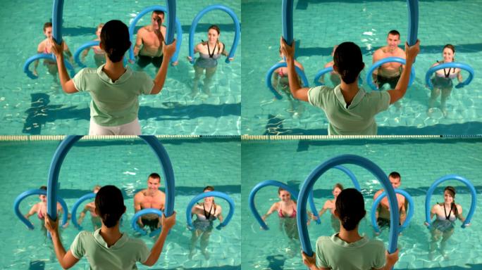 健身小组在泳池中进行有氧运动