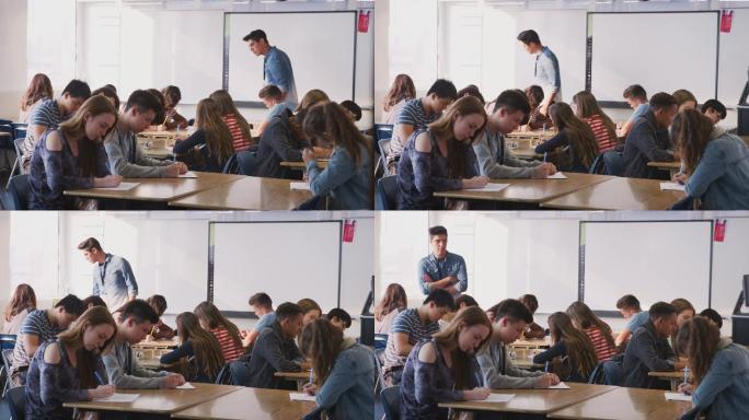 当学生上课时，男高中教师在课桌之间走动