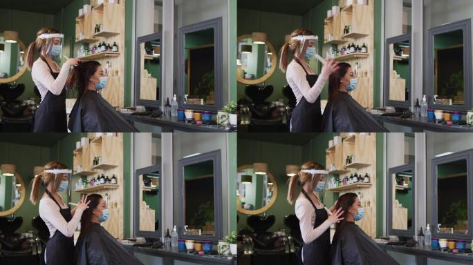 在美发沙龙戴面罩梳理女顾客头发的女美发师