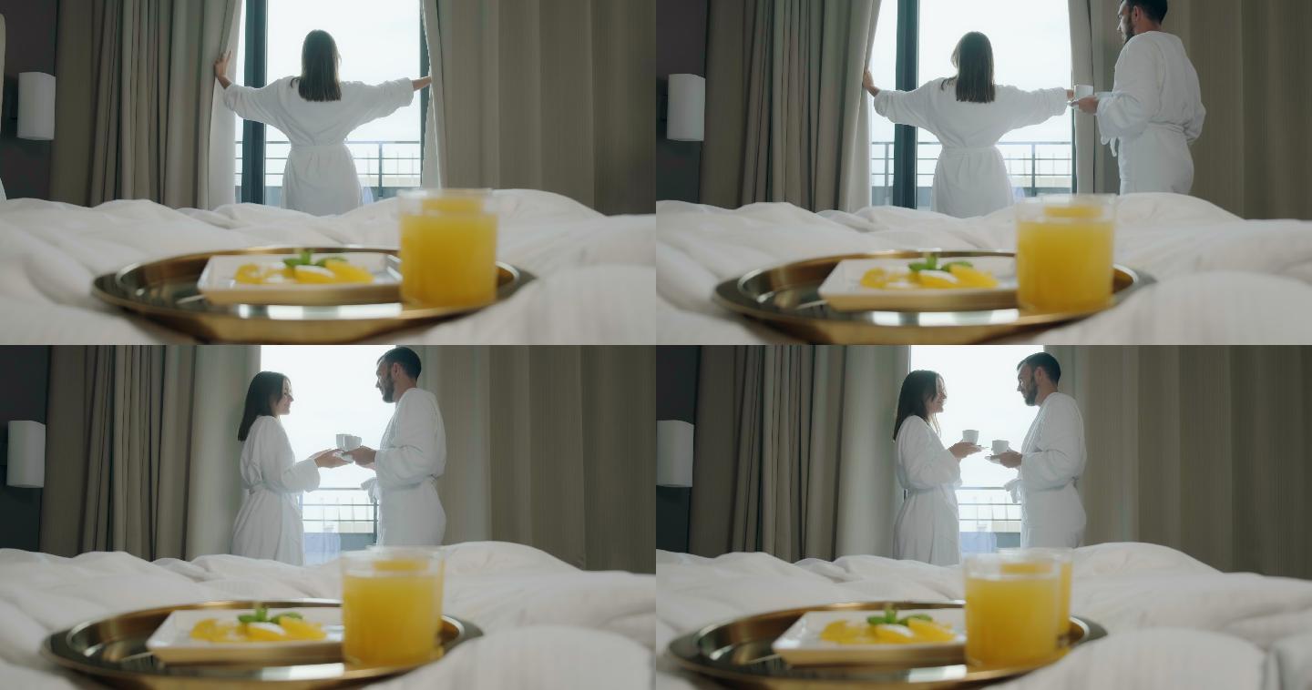 打开窗帘的女人酒店情侣早晨站在窗户边喝早