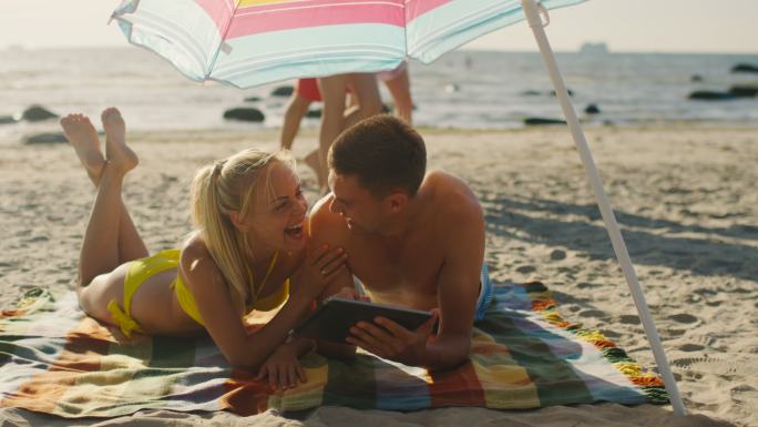 微笑的年轻夫妇沙滩情侣度假比基尼泳装互联