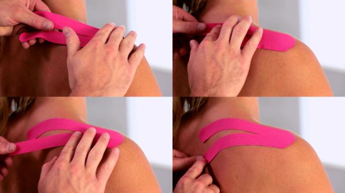 物理治疗师在患者背部使用粉色运动带