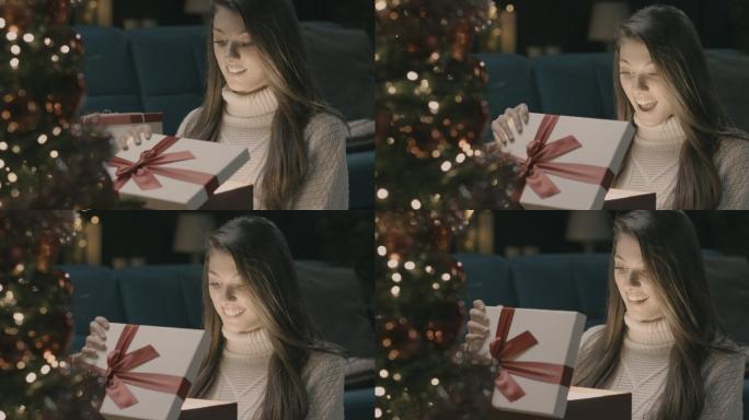 年轻女子正在打开圣诞盒。