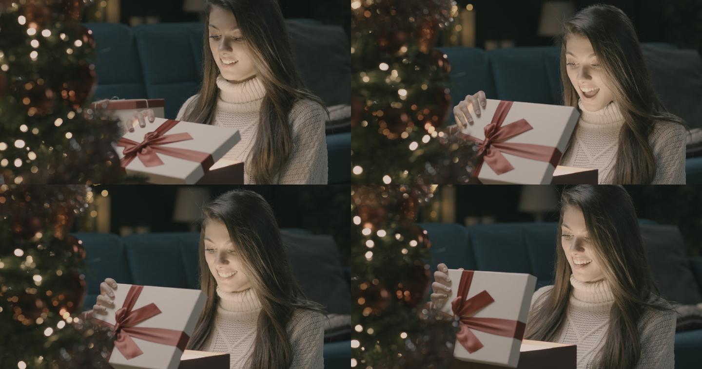 年轻女子正在打开圣诞盒。