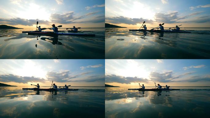 一群划桨者划过夕阳的水面