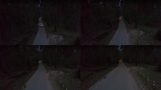 在夏季森林中黑暗的乡村道路上行驶