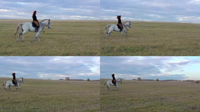 骑着白马的骑手。草原丘陵山坡骑手西部牛仔