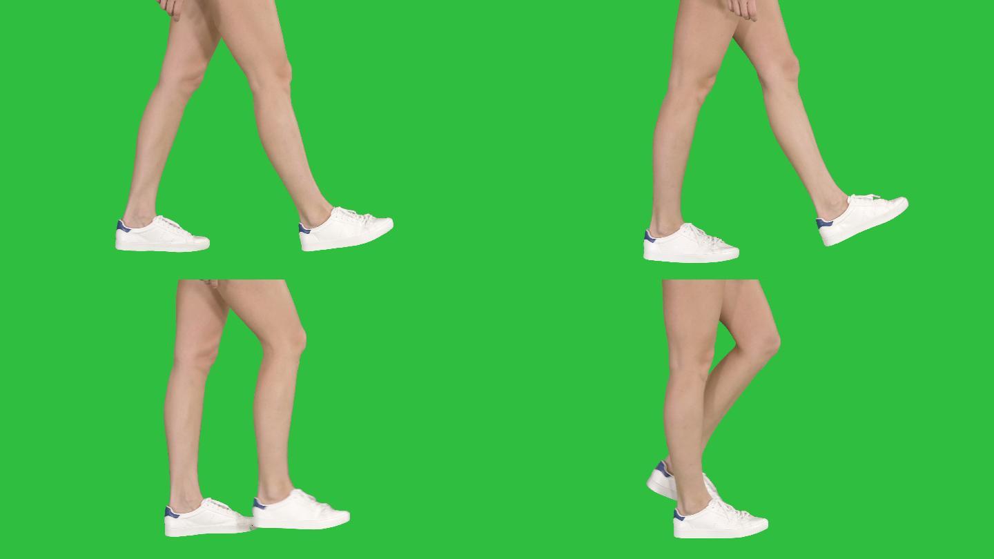 女性脚在绿色屏幕上行走