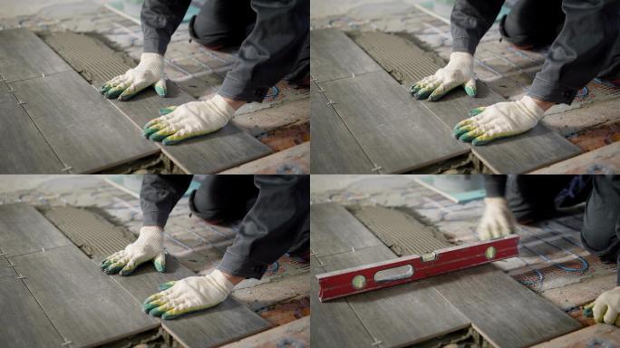 工人正在水泥和地板装置上方安装瓷砖地砖
