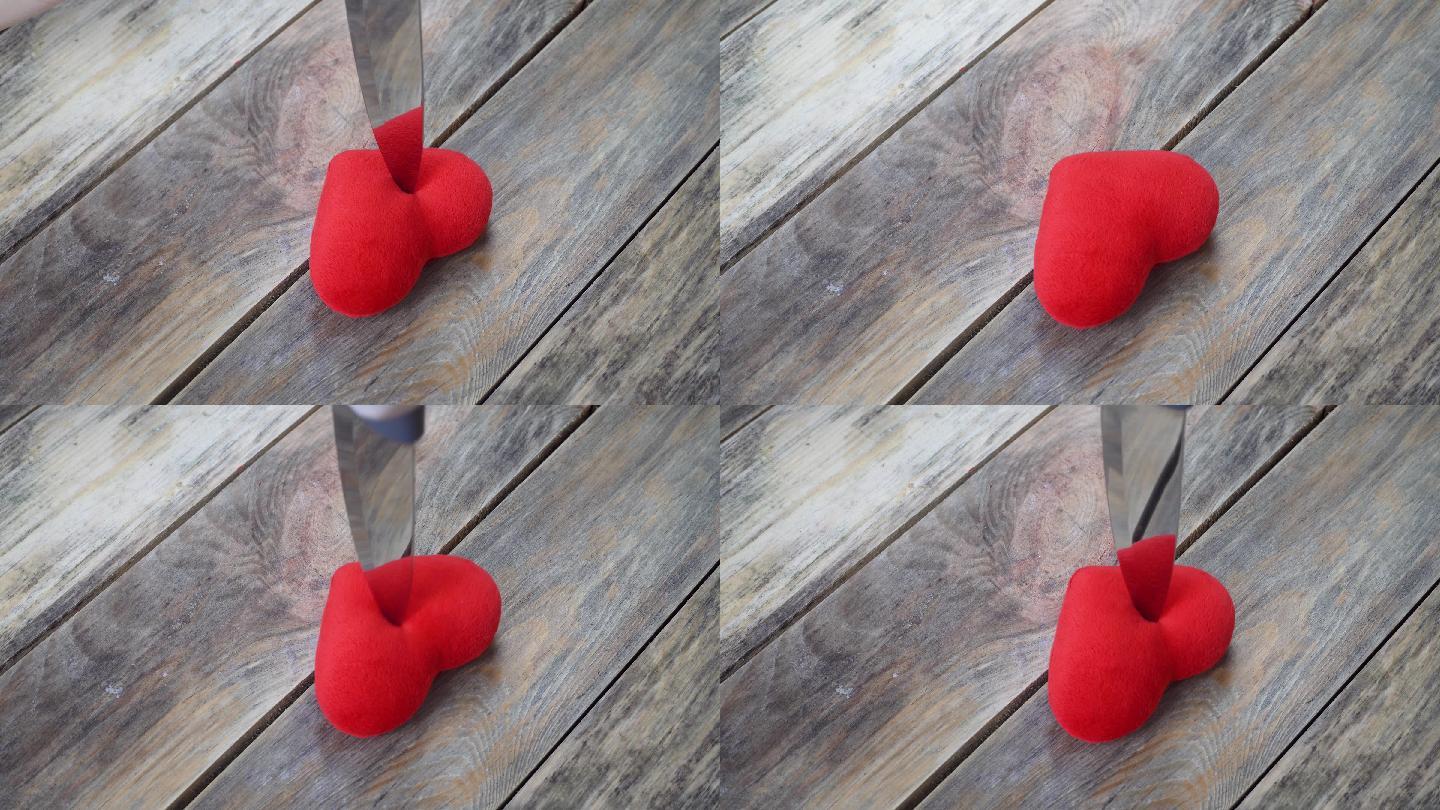 一个女人用刀刺伤模型心脏的特写镜头