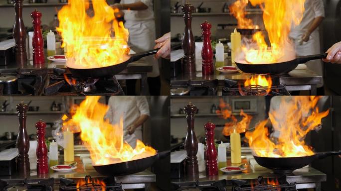 两位厨师在厨房煎虾的过程中。