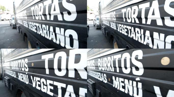 黑色食品车上的白色西班牙语单词