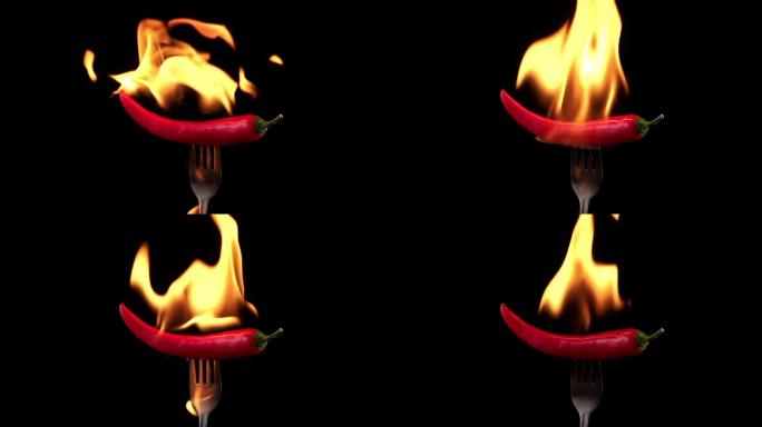 叉子上的红辣椒在火焰中燃烧